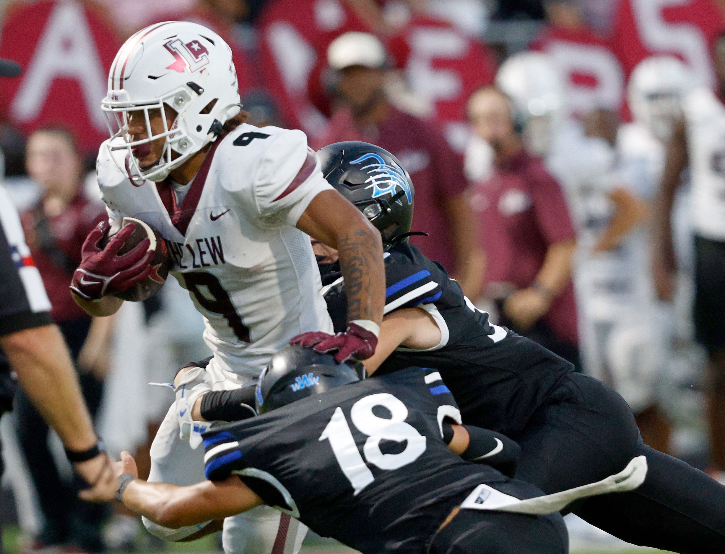 Lewisville's Tenel Hill (9) is tackled by Byron Nelson's Logan Cortez (18) and Byron...