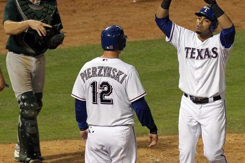 Texas Rangers right fielder Nelson Cruz (17) gestures as he arrives at home plate after...