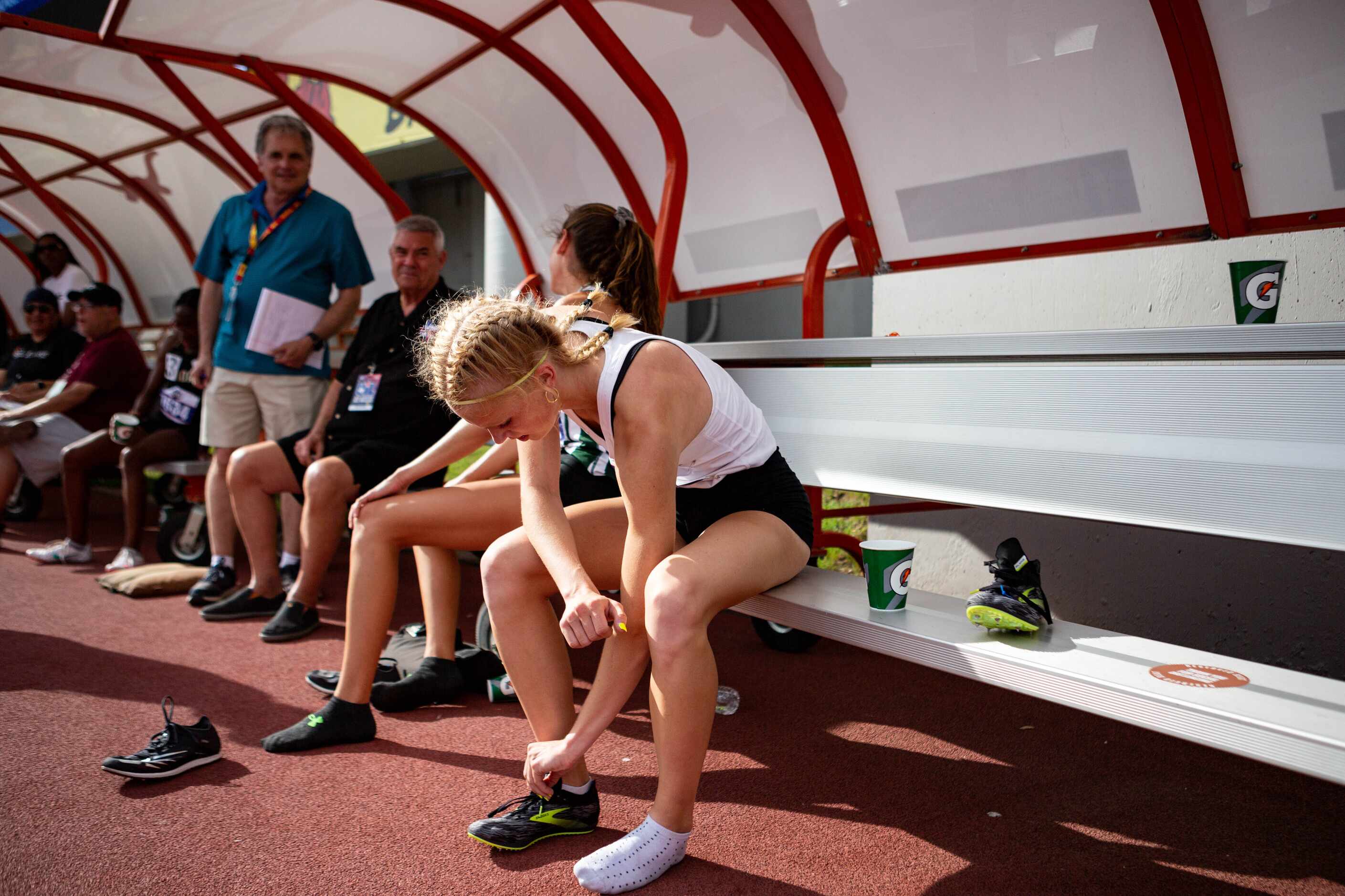 Kailey Littlefield of Lucas Lovejoy unties her cleats after winning the girls’ 800m final at...