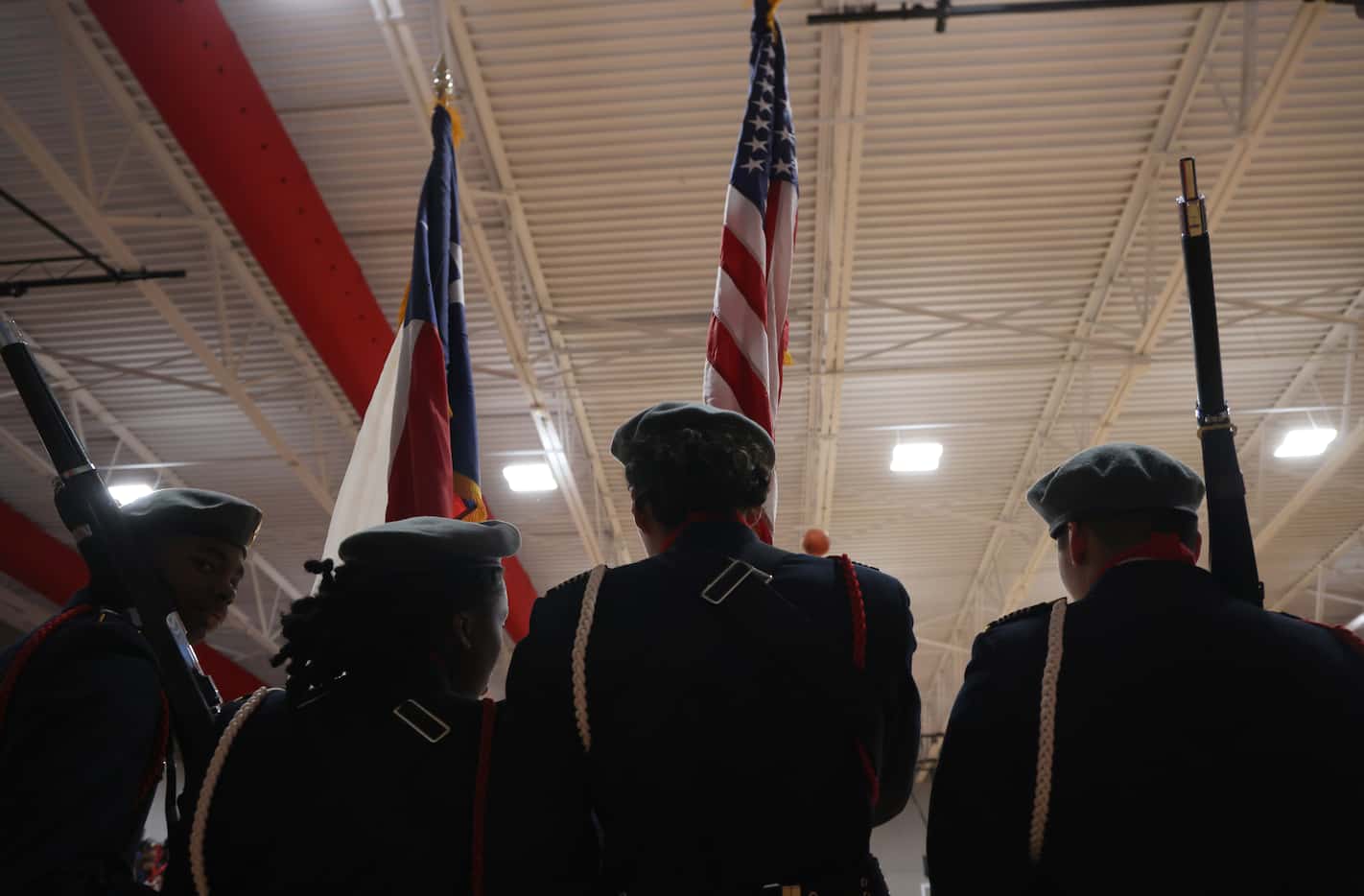 Members of the Dallas Carter junior ROTC honor guard await advancing to center court for the...