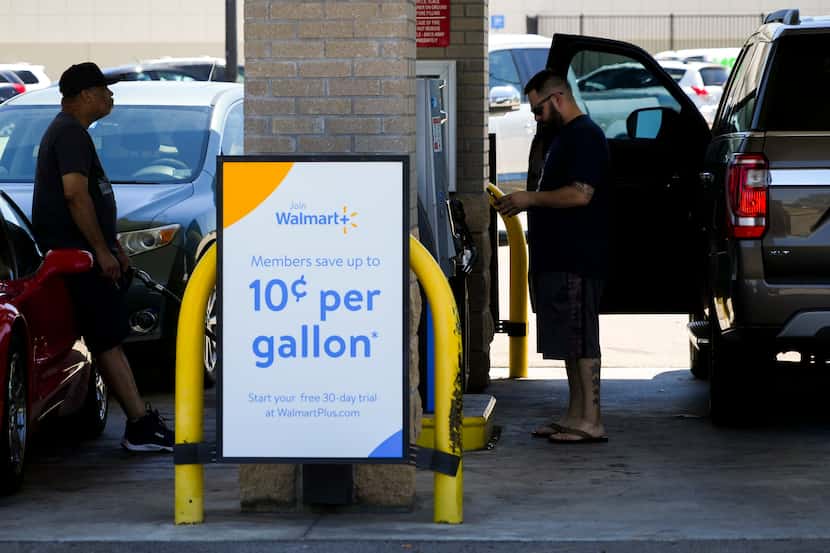 Customers pump gas as a Walmart in the 4800 block of S. Cooper Street where the price was of...