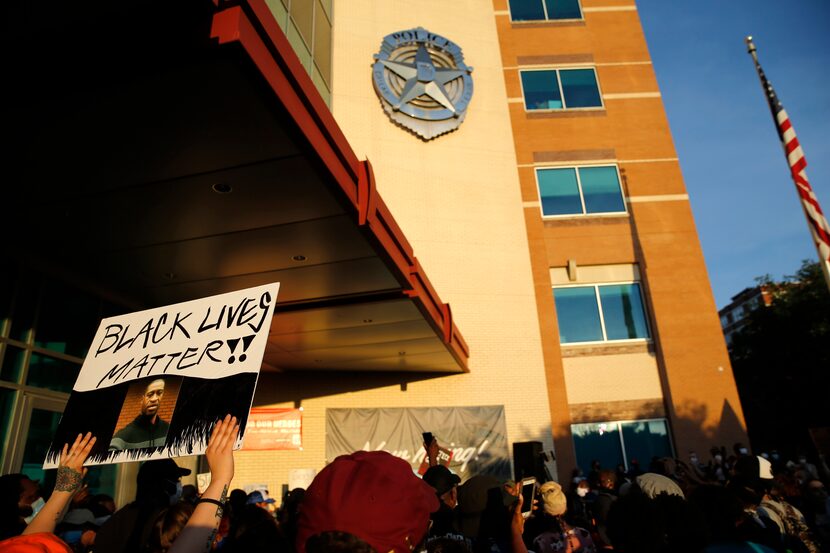 Protesters rally during a demonstration against police brutality in front of Dallas Police...