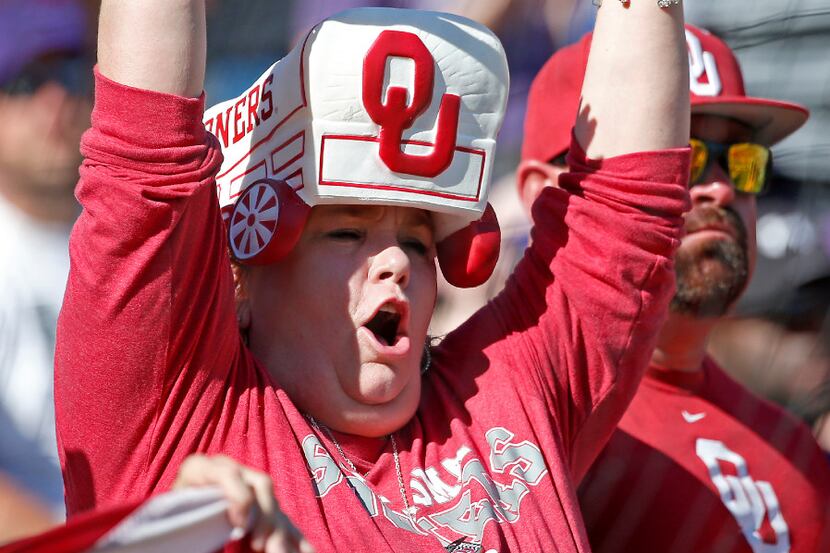 An Oklahoma fan cheers for her team against TCU during the first quarter at Amon G. Carter...