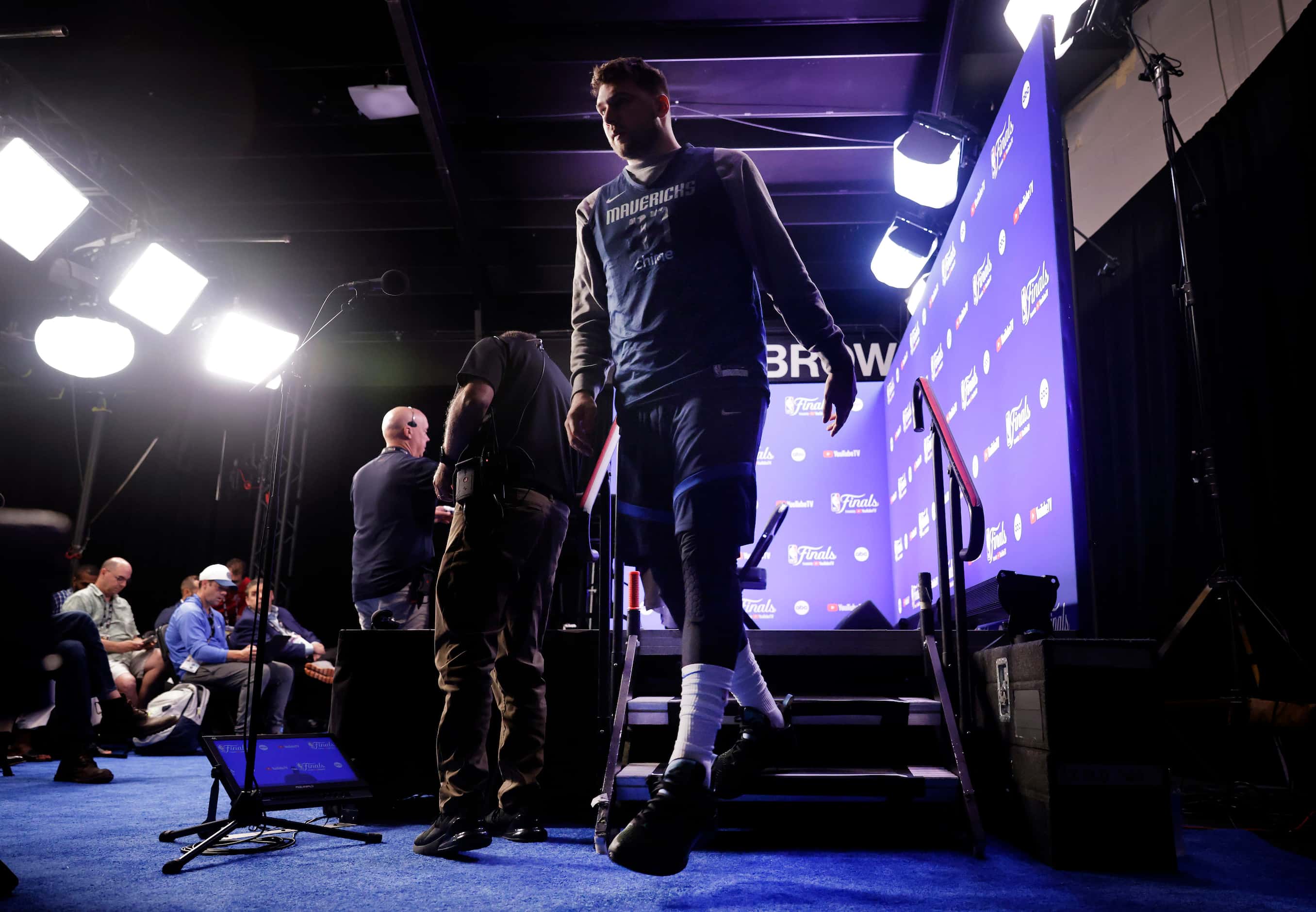Dallas Mavericks player Luka Doncic steps off the stage after answering questions from the...
