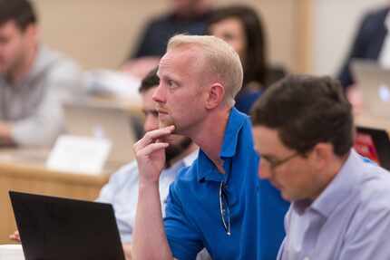 Second-year MBA students Brenton Schiffer, foreground, and Patrick Meden listen to a lecture...
