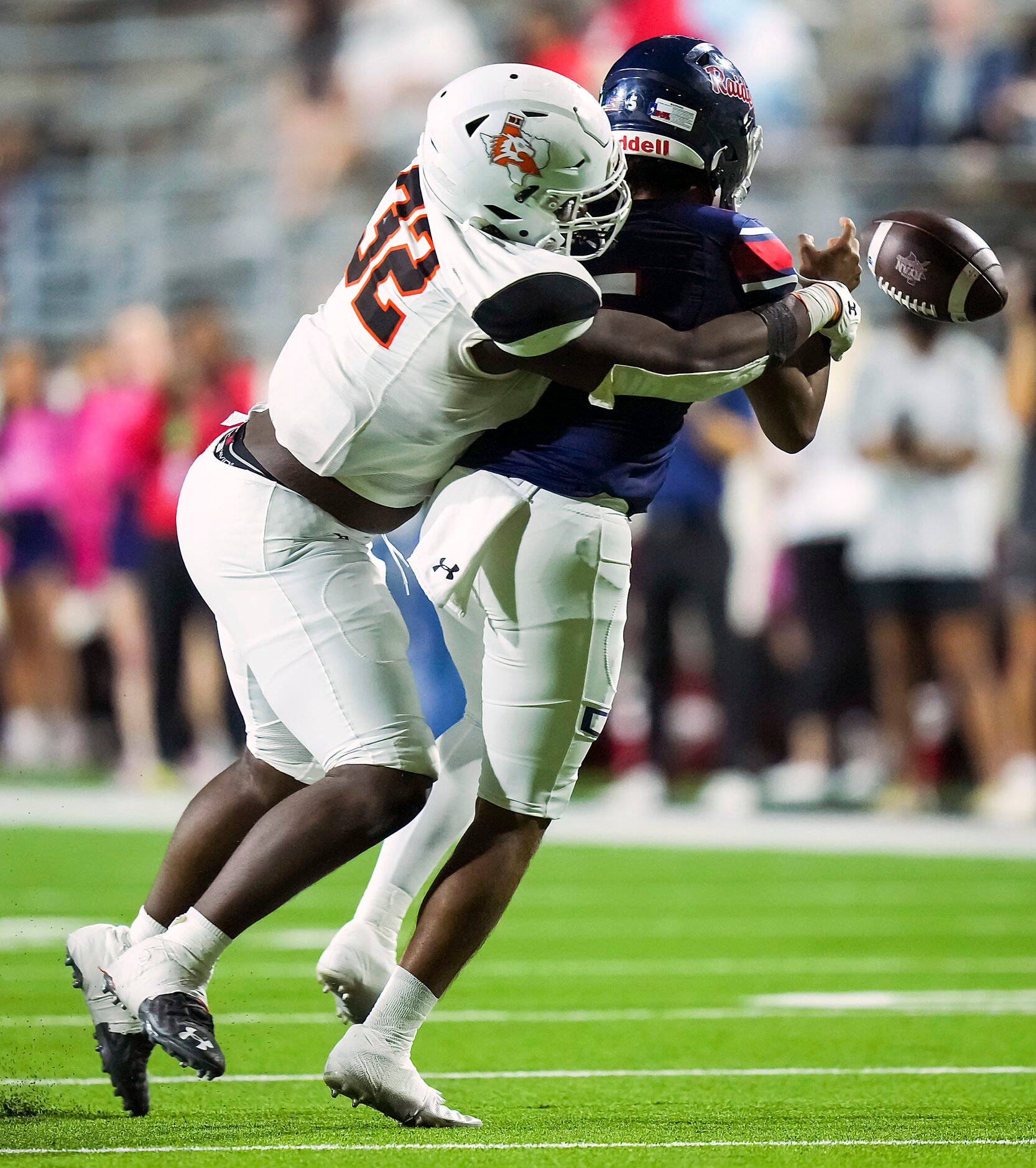 Denton Ryan quarterback Khalon Davis (5) tries to pass as he is pulled down by Aledo...