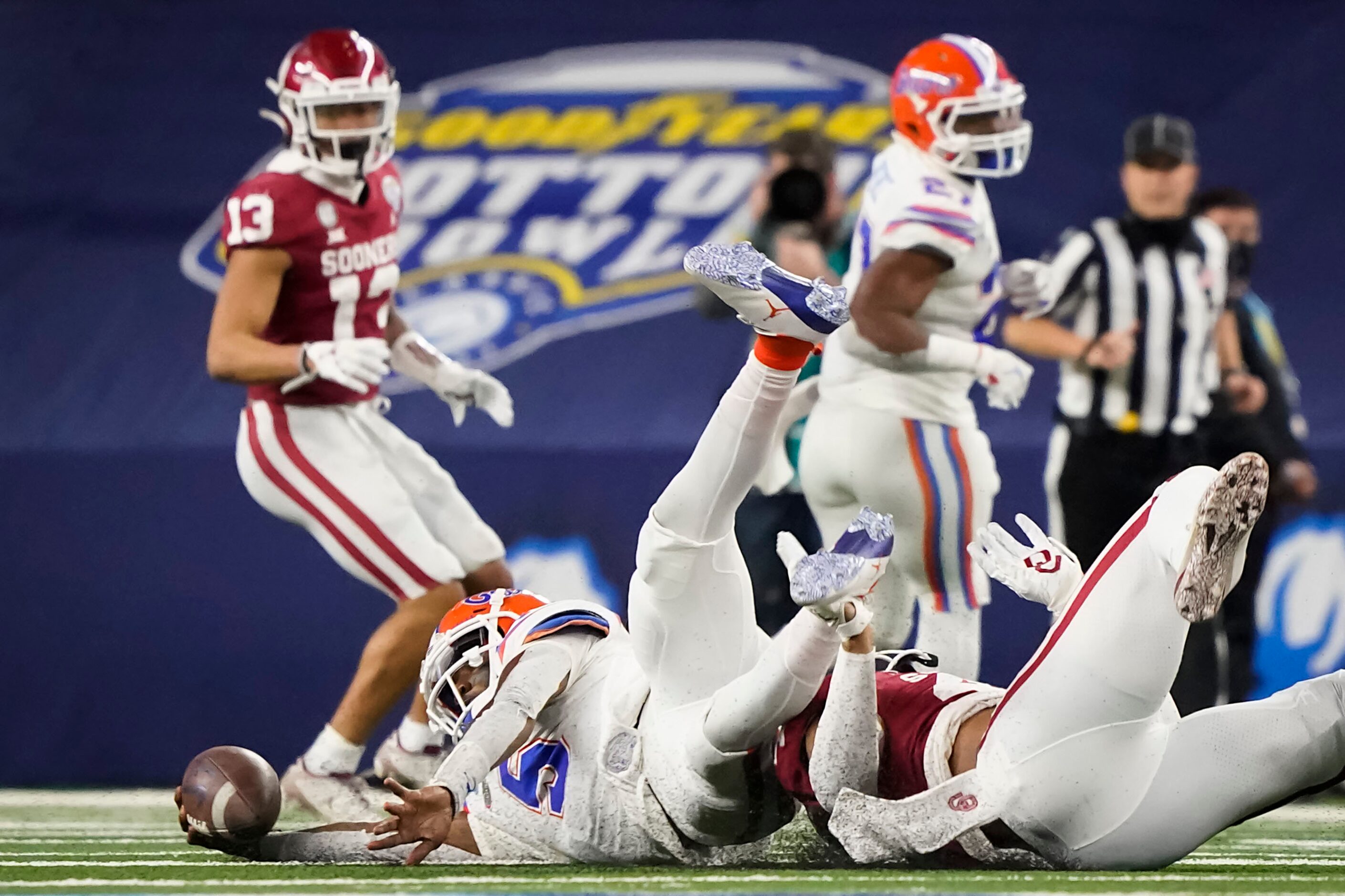 Florida quarterback Emory Jones (5) is brought down by Oklahoma linebacker Jon-Michael Terry...