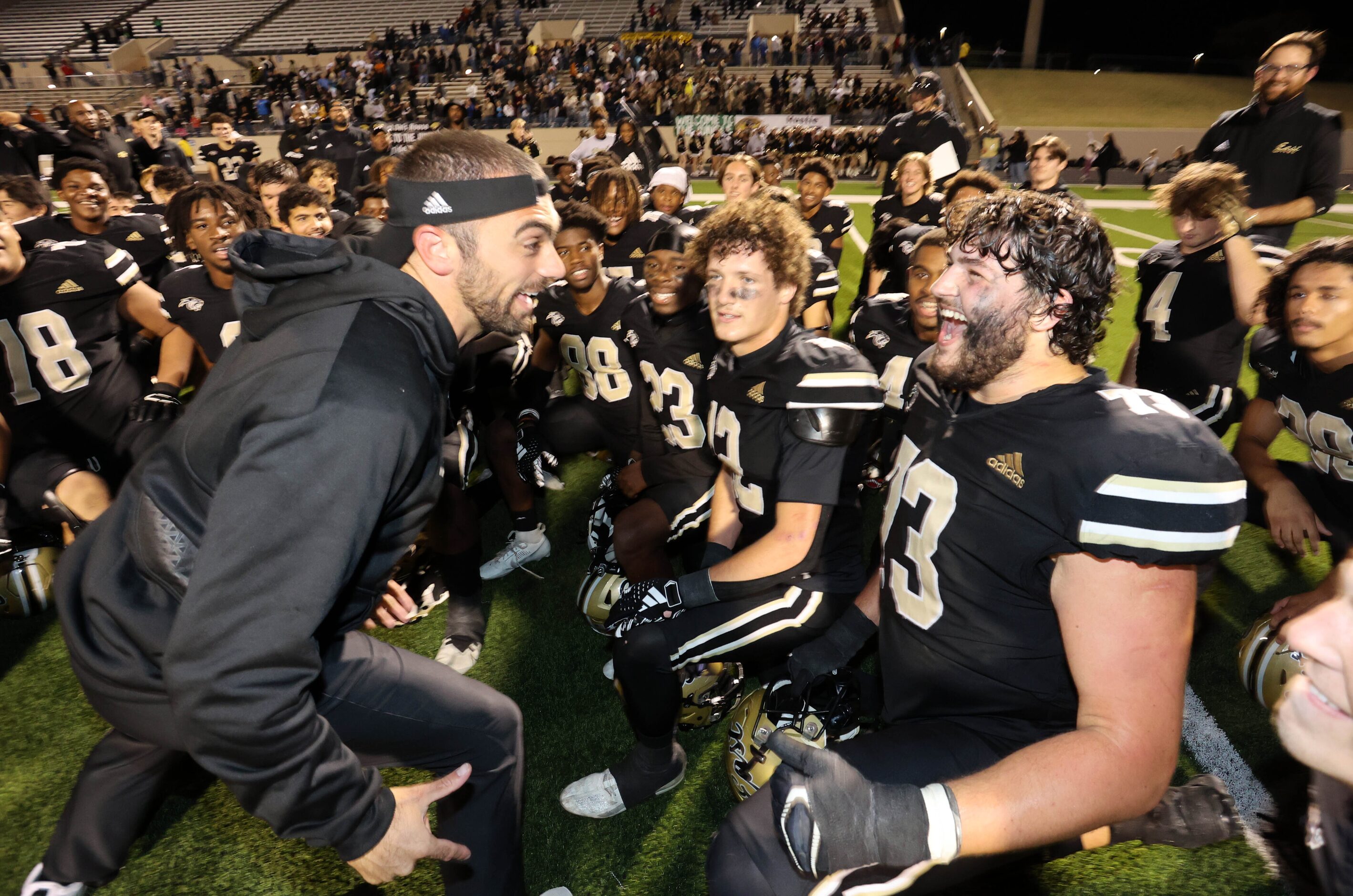 Plano East High head coach Tony Benedetto (left) celebrates with player Corbin Glass (73)...