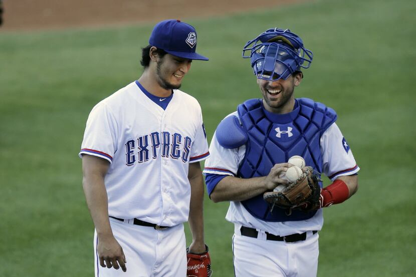Texas Ranger pitcher Yu Darvish, left, walks to the dugout during a rehab start for Triple-A...