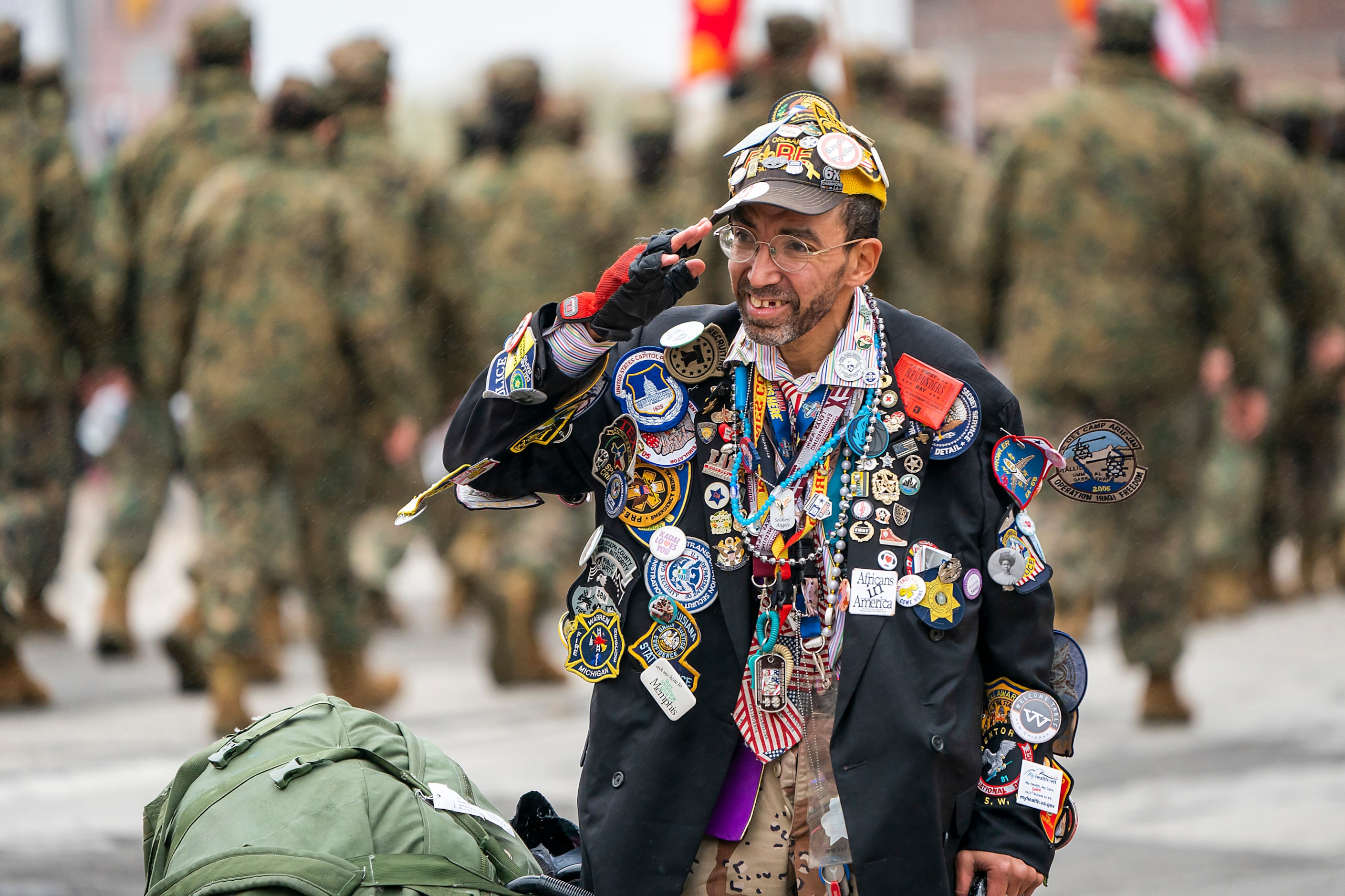 Rev. Mark ÒPinmanÓ Perez salutes as a JROTC group passes City Hall during The Greater Dallas...