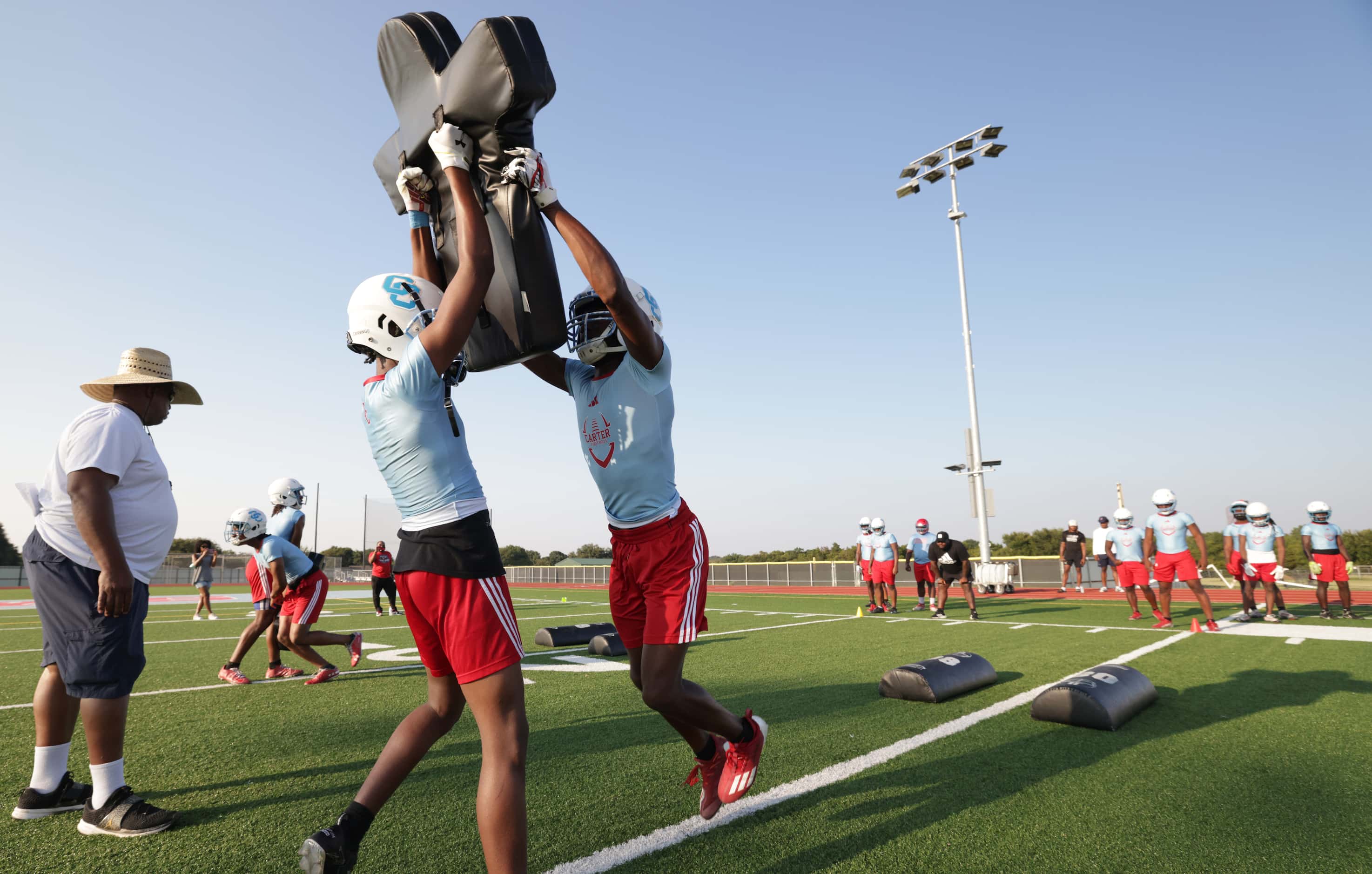 Players attend their first day of football practice at Carter High School in Dallas, TX, on...