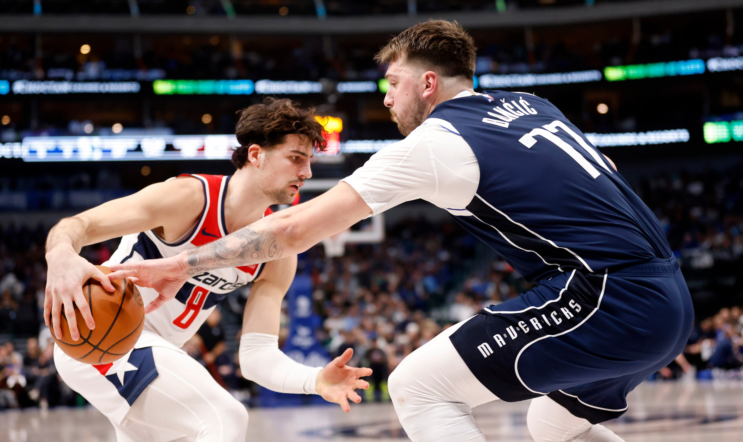 Dallas Mavericks guard Luka Doncic (77) swats the ball from Washington Wizards forward Deni...