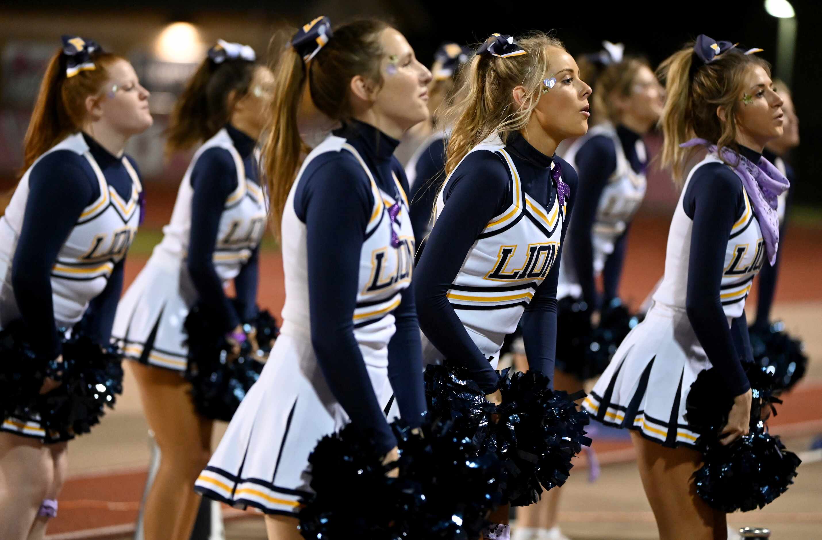 Prestonwood cheerleaders perform in the first half of a high school football game between...
