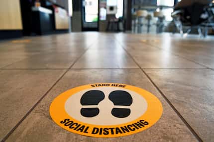 Social Distancing decals inform customers where to stand inside the newly opened McDonald's...