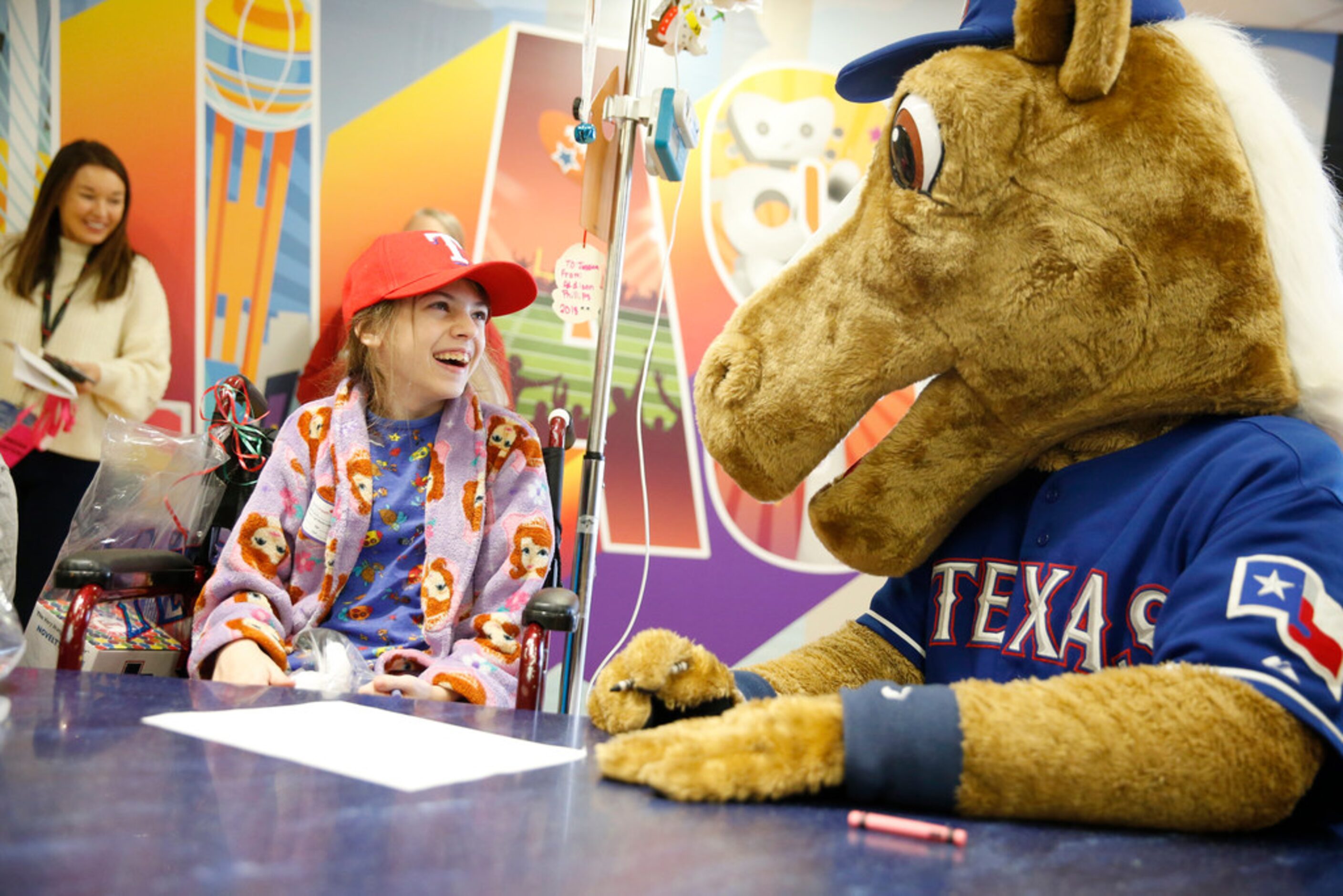 Jessica Bass, 14, laughs along with Rangers Captain as the Texas Rangers visit Children's...