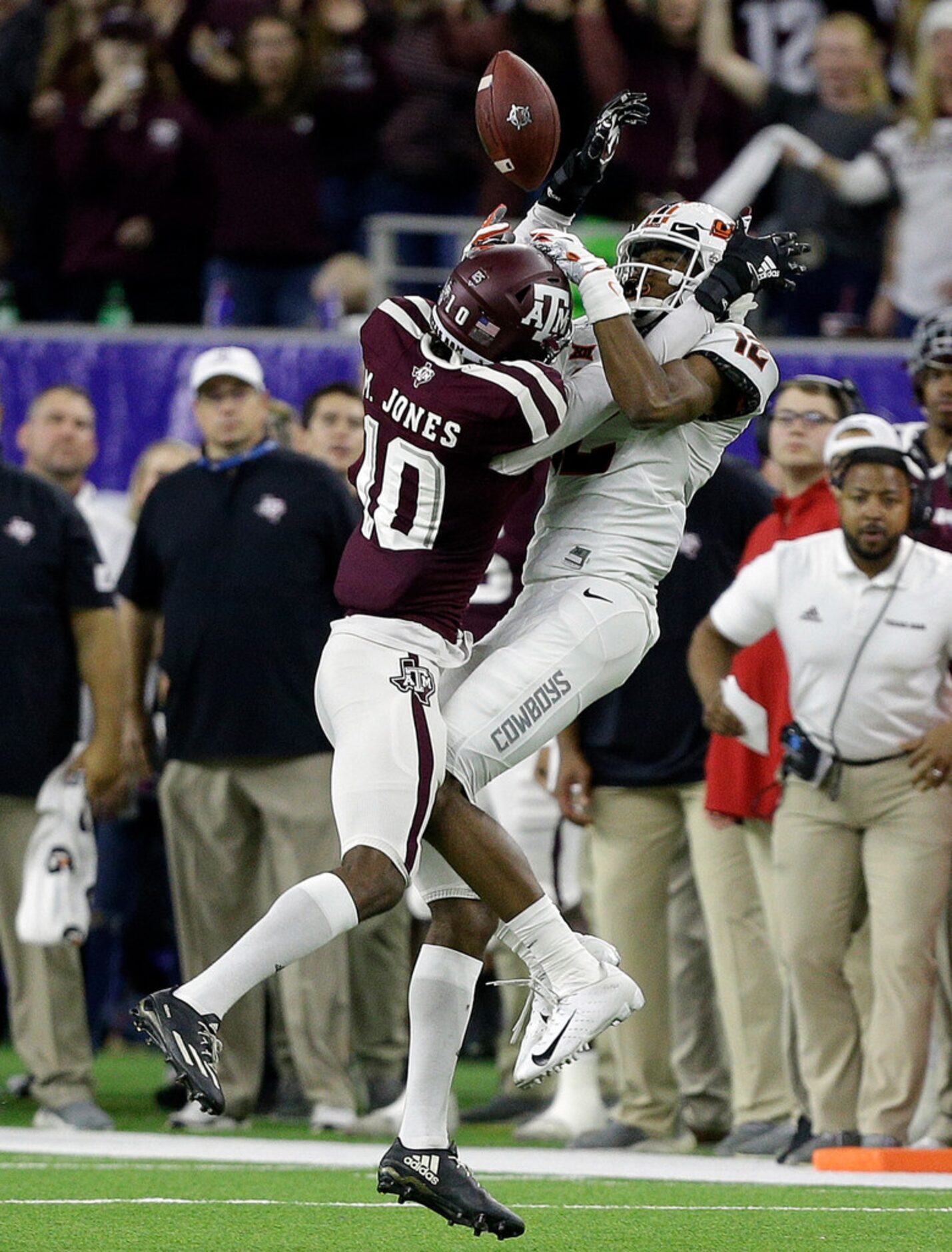 HOUSTON, TEXAS - DECEMBER 27: Myles Jones #10 of the Texas A&M Aggies breaks up a pass...