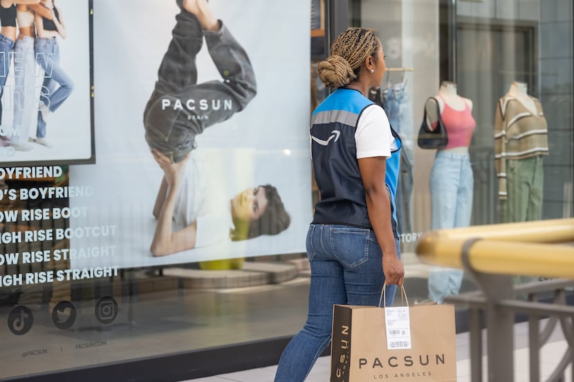 An Amazon driver leaves a PacSun mall store with a same-day delivery for a PacSun customer.