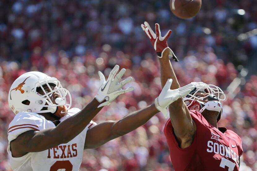 Texas Longhorns wide receiver Dorian Leonard (8) catches a pass while being covered by...