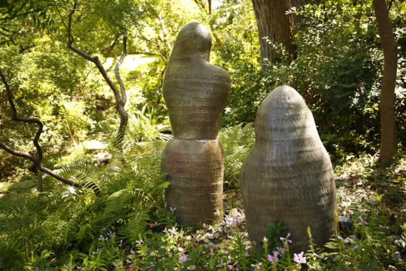 On the property's hill are three stylized ceramic figures that seem to “have crept in from...