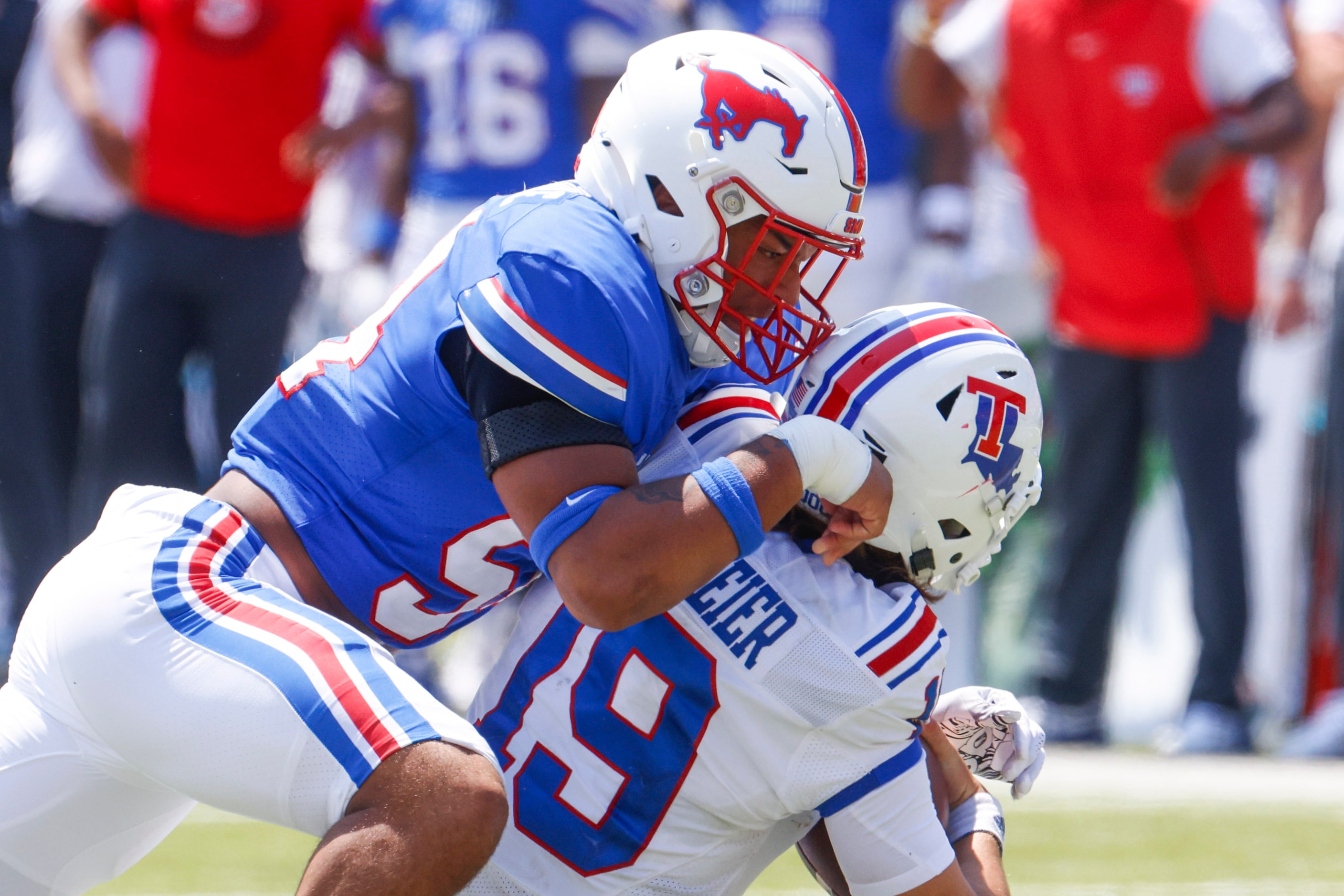 Southern Methodist linebacker Alexander Kilgore (left) sacks Louisiana Tech quarterback Hank...