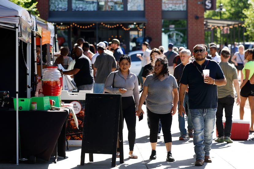 People walk around Dallas Farmers Market a day before total solar eclipse on Sunday, April...