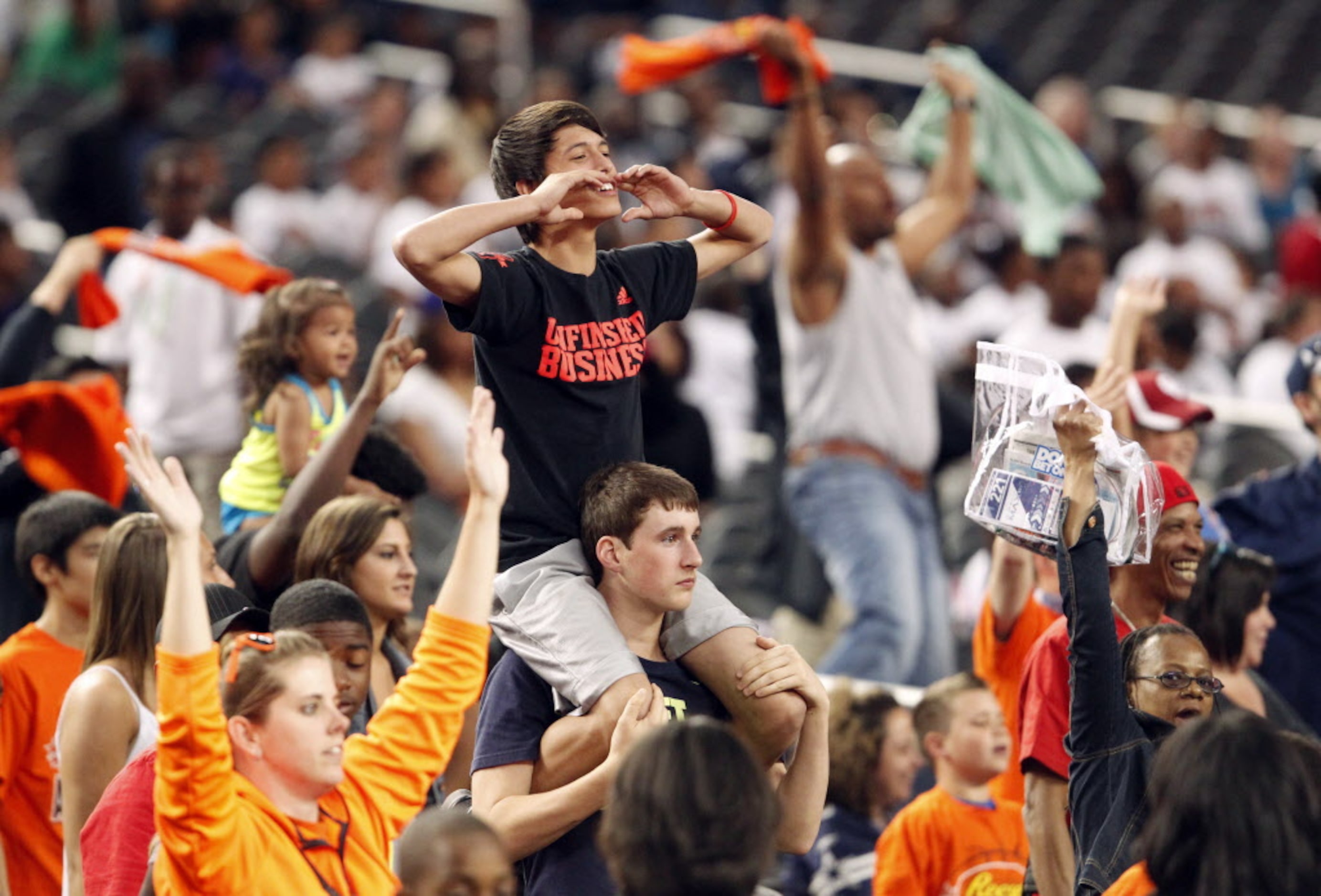 Fans try to win tickets to one of the Final Four games by cheering during the Reese's Final...