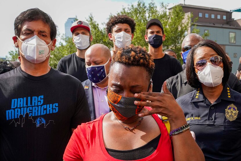 Dallas Mavericks owner Mark Cuban (left) stands with Rev. Stacey Brown, who wipes her eyes, ...