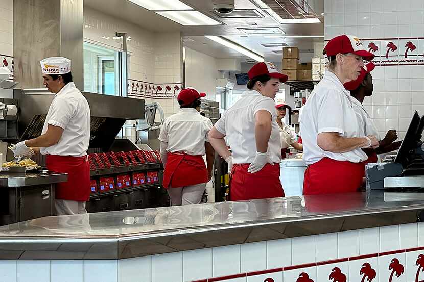 Workers prepare food and take orders an In-N-Out burger restaurant Aug. 8 in Thornton, Colo.