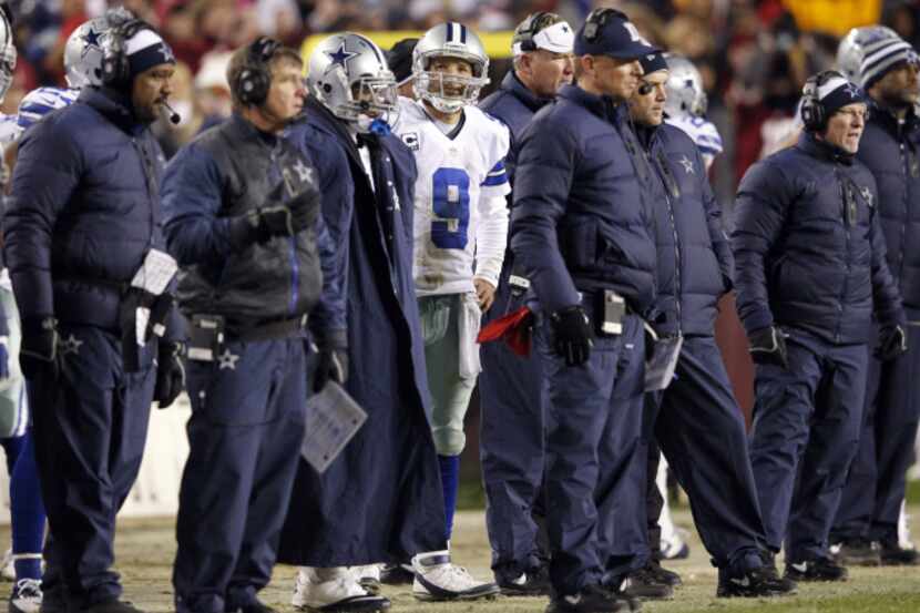 Dallas Cowboys quarterback Tony Romo (9) looks back at the scoreboard after failing to make...