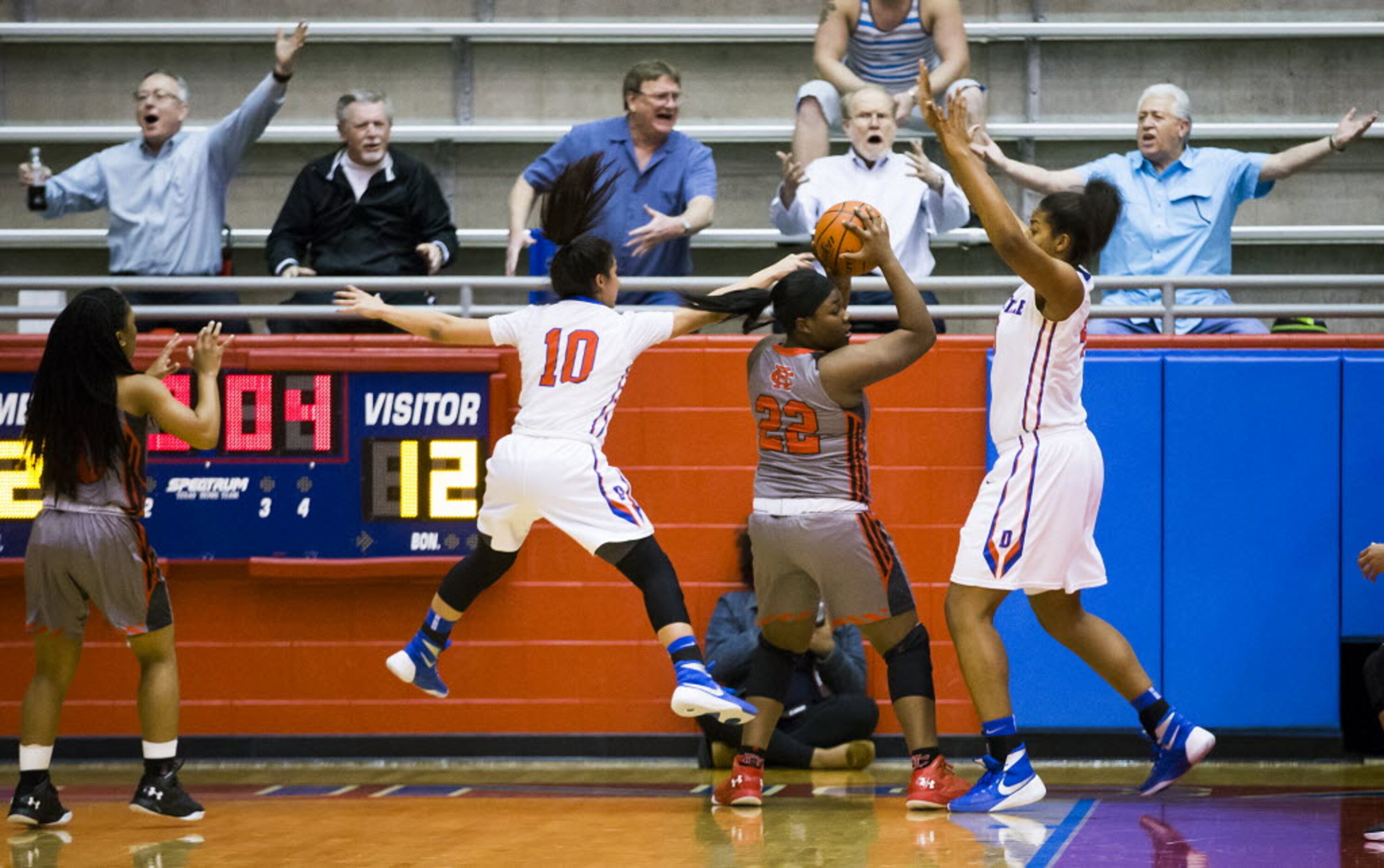 Duncanville fans scream for a foul on Cedar Hill forward Taylor Hutchins (22) as she is...