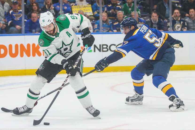 Dallas Stars center Tyler Seguin (91) makes a pass as he is defended by St. Louis Blues...