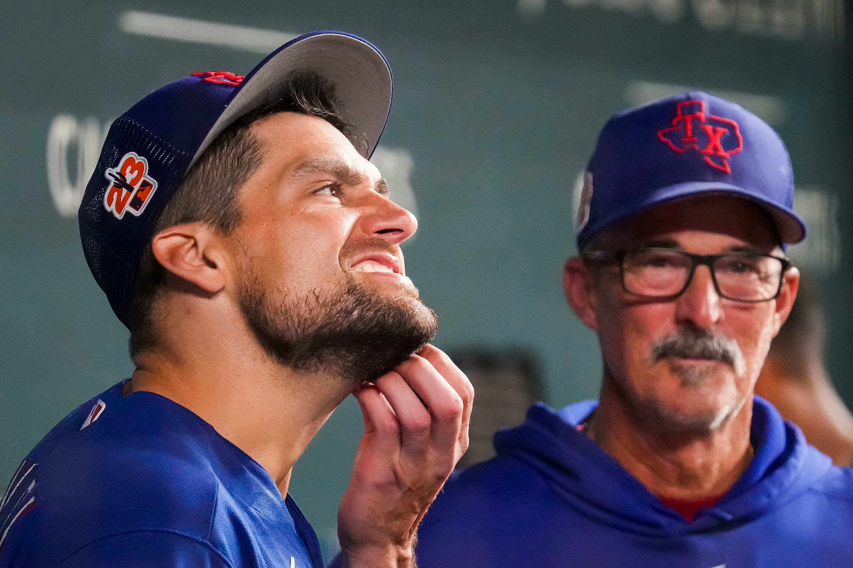 Texas Rangers starting pitcher Nathan Eovaldi  rubs his chin as he talks with pitching coach...