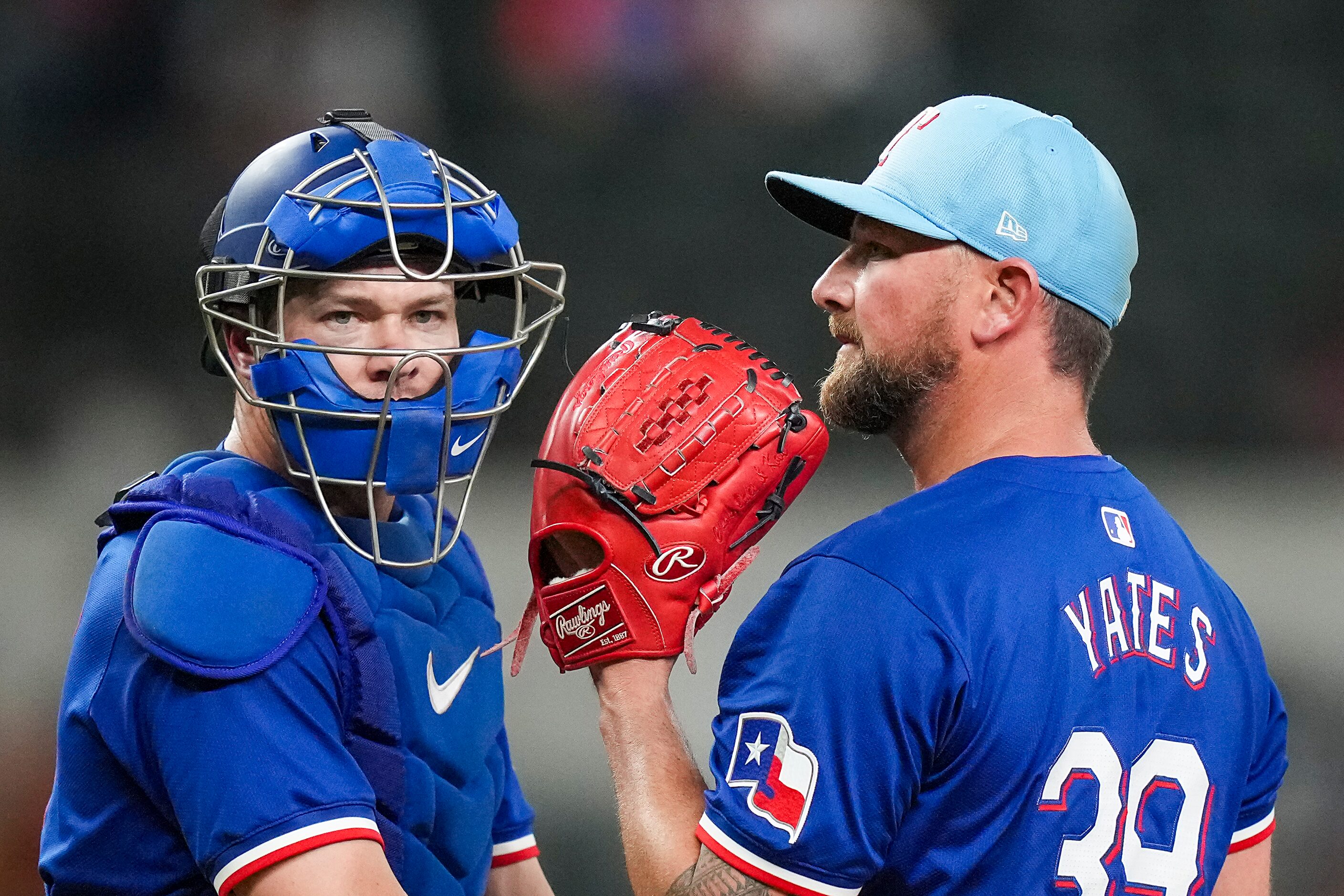 Texas Rangers pitcher Kirby Yates gets a visit from catcher Andrew Knapp during the ninth...