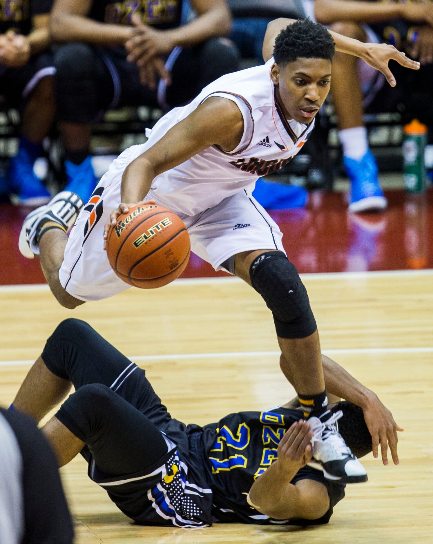 Lancaster guard/forward Josh Johnson (5) steps on the face of Beaumont Ozen guard John...