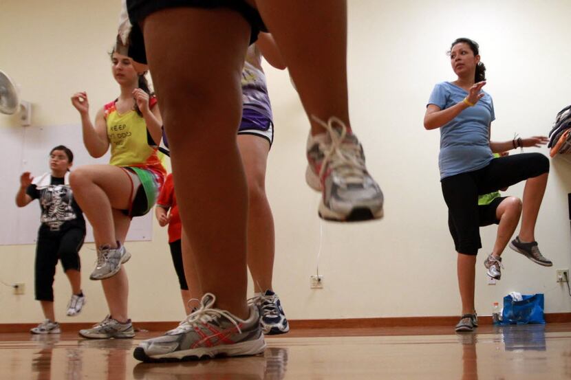 In this file image, Zumba participants can be seen exercising during a class.