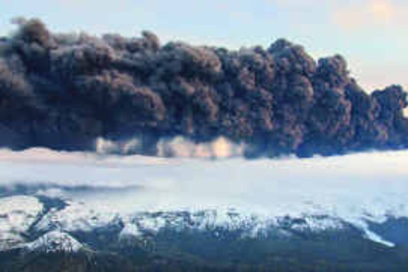  Smoke and steam hover above the Eyjafjallajokull glacier. A volcano under the glacier...