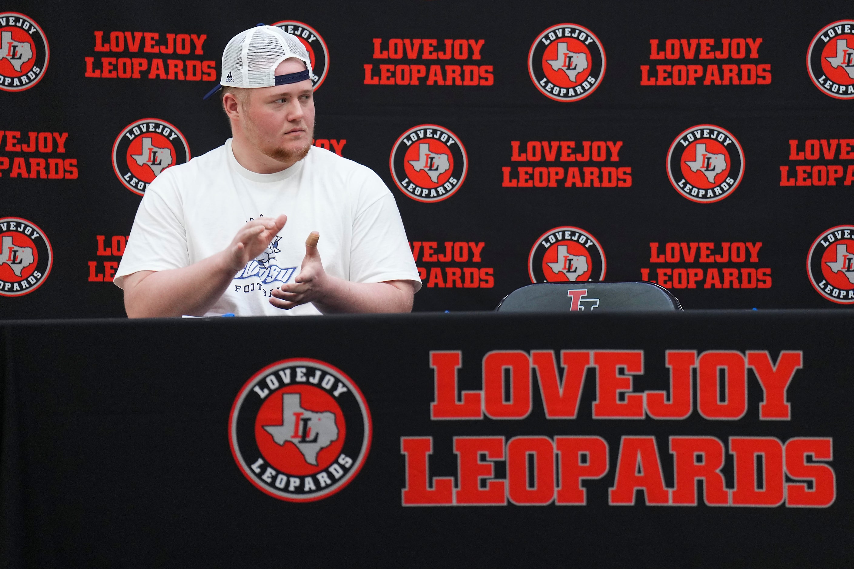 Lovejoy all-state offensive lineman Sam Reynolds applauds comments about a teammate during a...