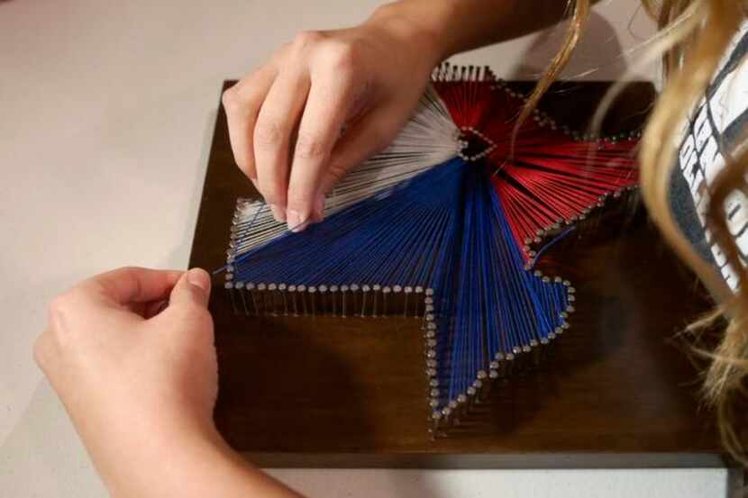 
Kaitlin Capetillo works on one of her Custom Made String Art pieces at her home in Dallas...