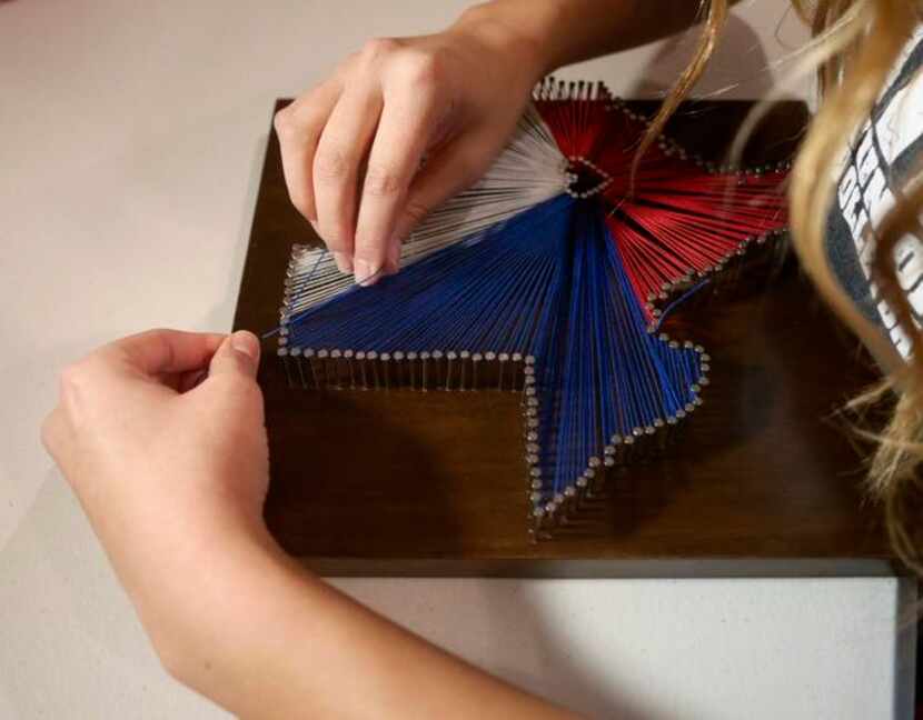 
Kaitlin Capetillo works on one of her Custom Made String Art pieces at her home in Dallas...