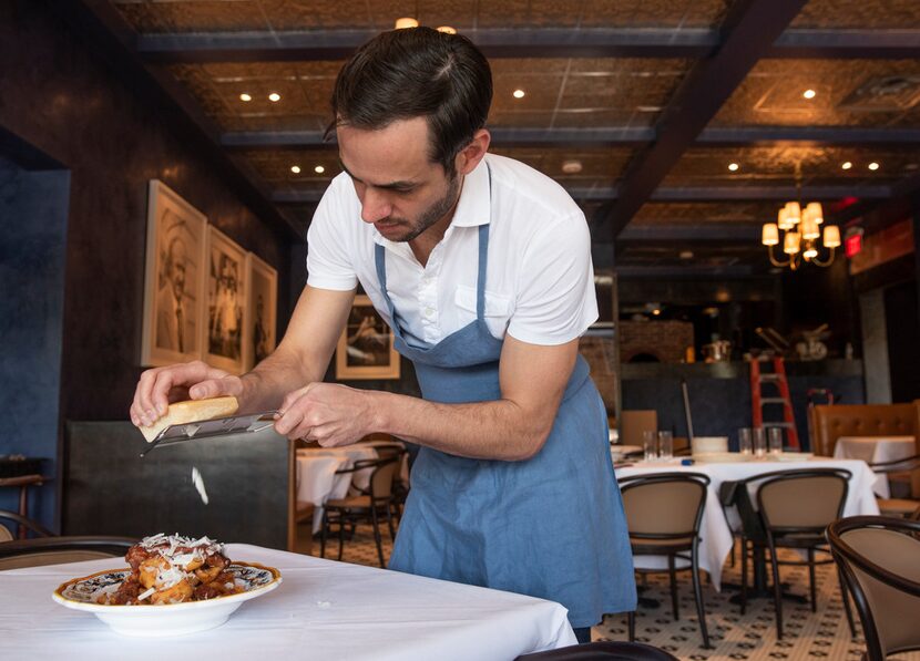 Julian Barsotti adds cheese to his Sunday gravy.