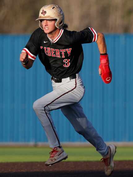 Liberty shortstop Cade McGarrh heads to third base on his way to scorring the game’s first...