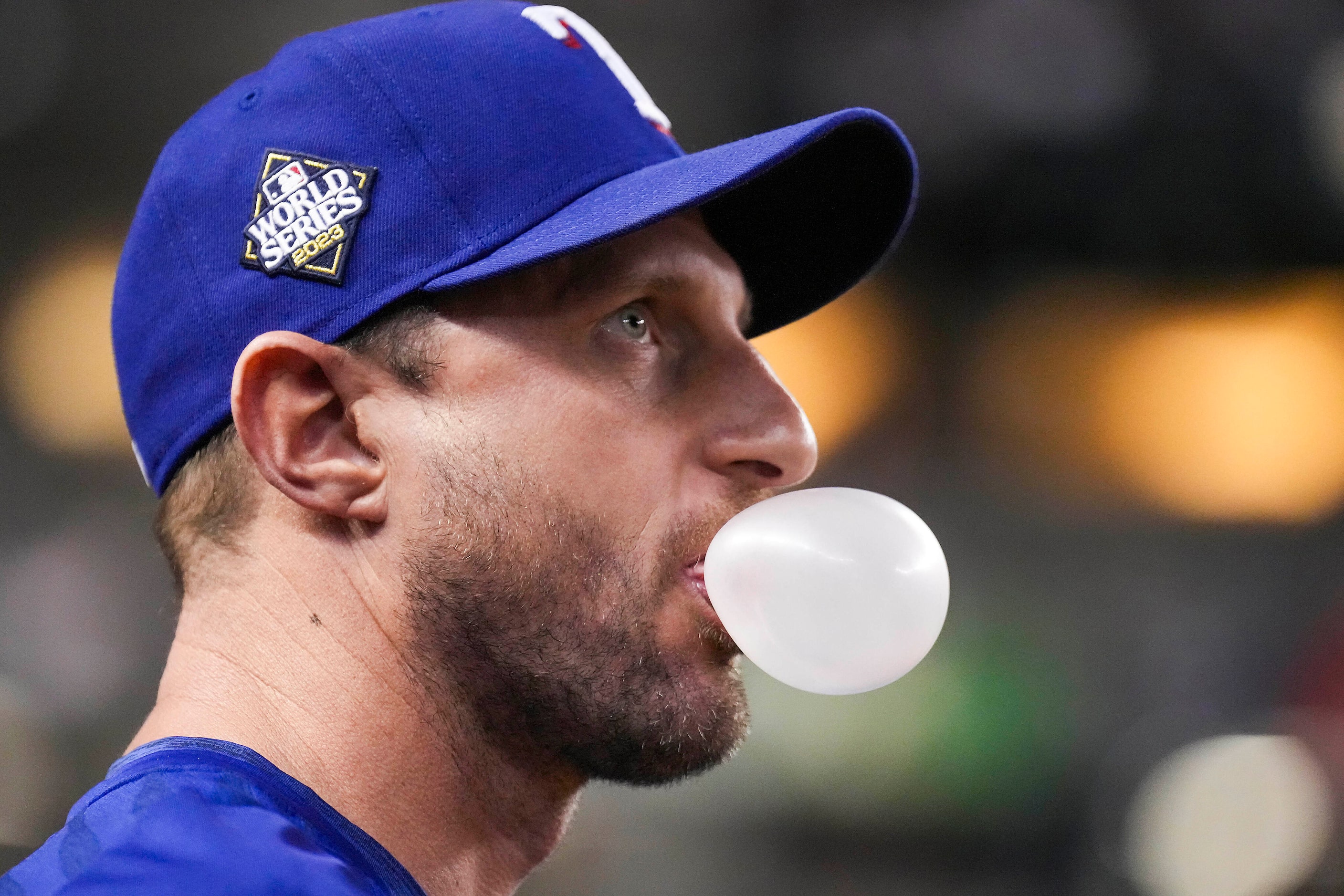 Texas Rangers starting pitcher Max Scherzer looks on from the dugout during the fourth...