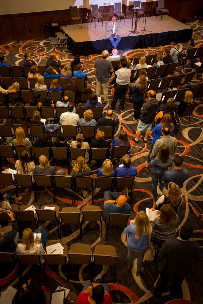 Residents line up for a Q&A with water consultant Bob Bowcock duirng a town hall style...