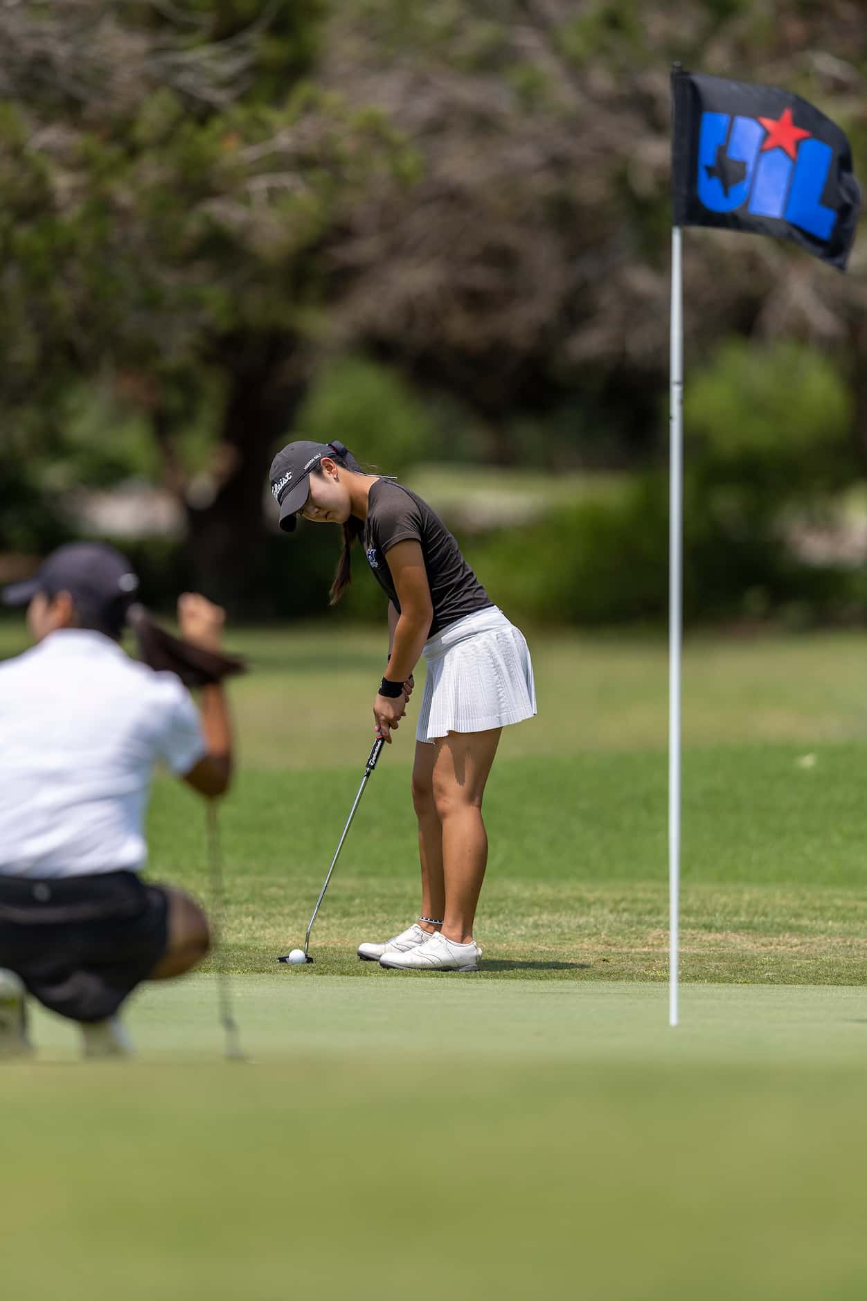 Hebron’s Estelle Seon putts on the 8th green during the 6A girls state golf tournament in...