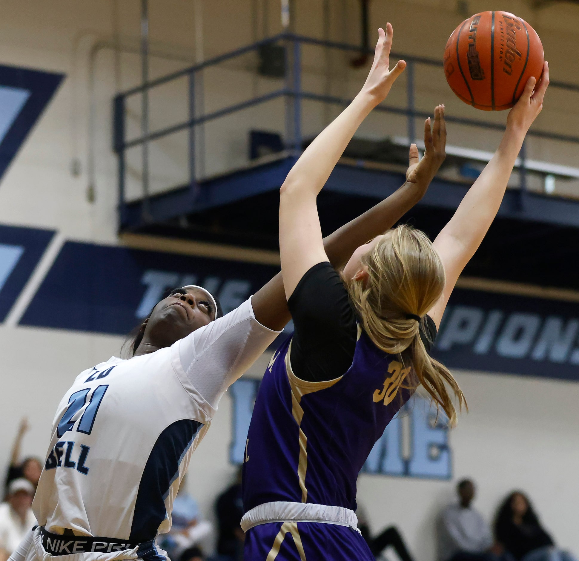 Hurst L.D. Bell forward Gracie Oma (21) and  Saginaw Chisholm Trail center Claire Blakley...