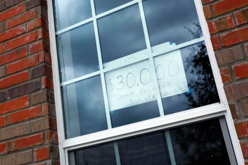 
A handwritten sign in the window of 2837 Tudor Lane in Irving advertises down payment...