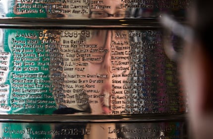 Arnela Muhic takes a close look at the 1998-99 Dallas Stars team names on the Stanley Cup,...