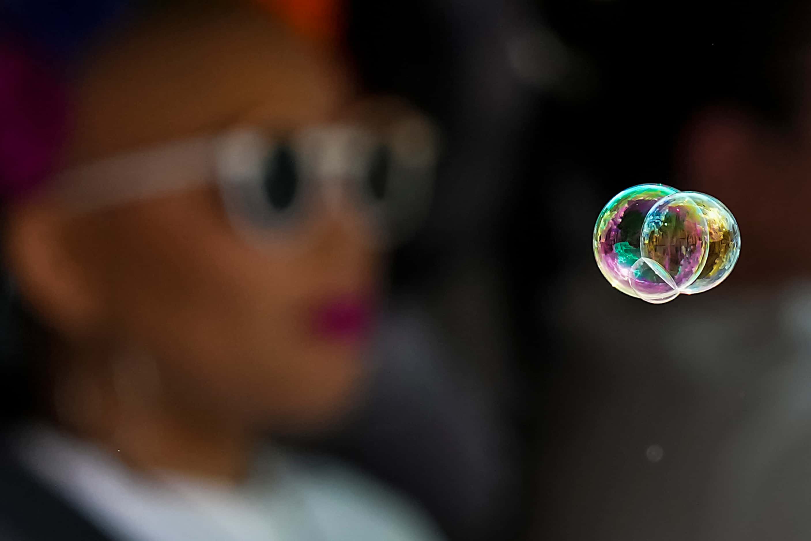 Soap bubble float past as participants ride in a vehicle during the annual Alan Ross Texas...