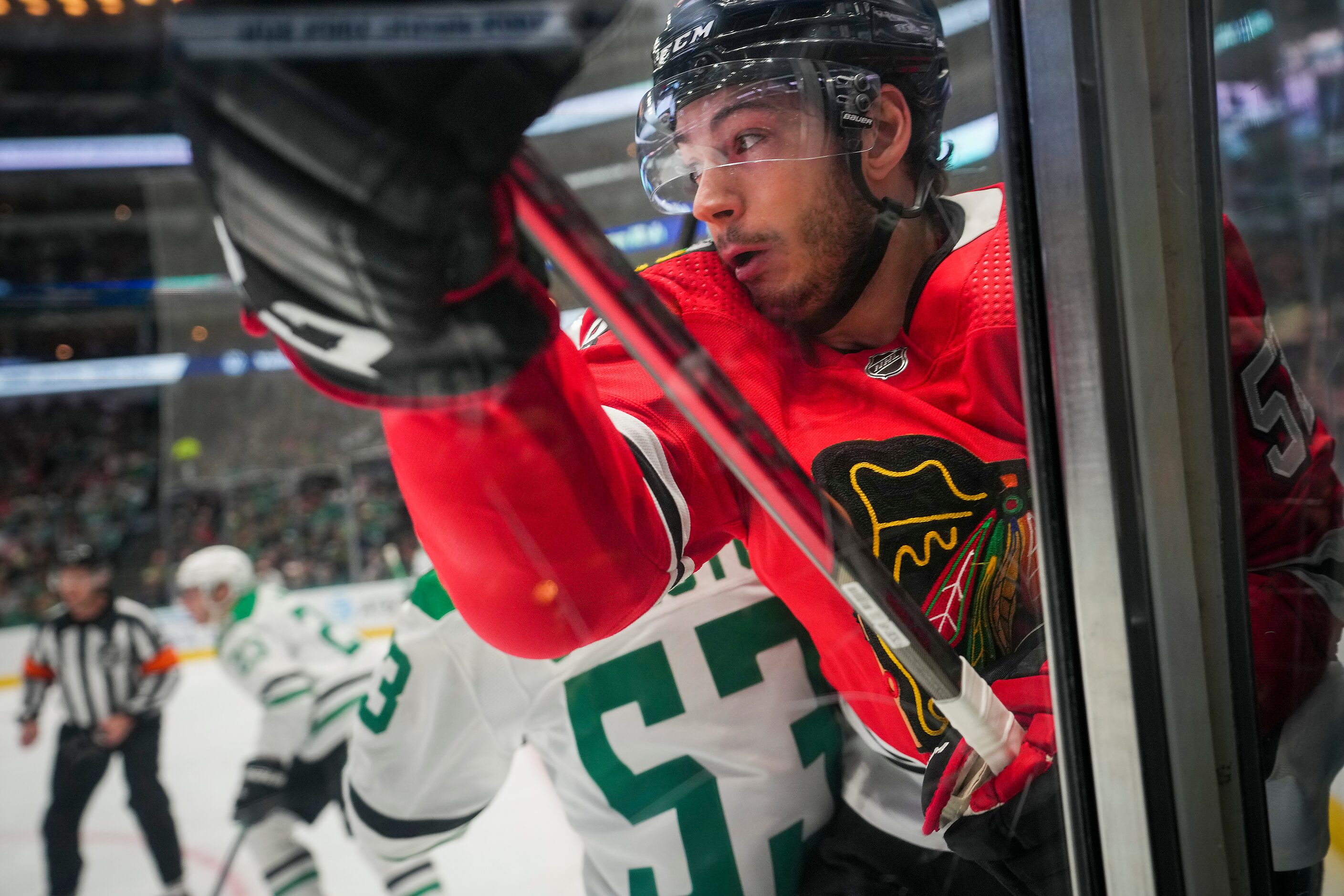 Chicago Blackhawks center Reese Johnson (52) is checked by Dallas Stars center Wyatt...