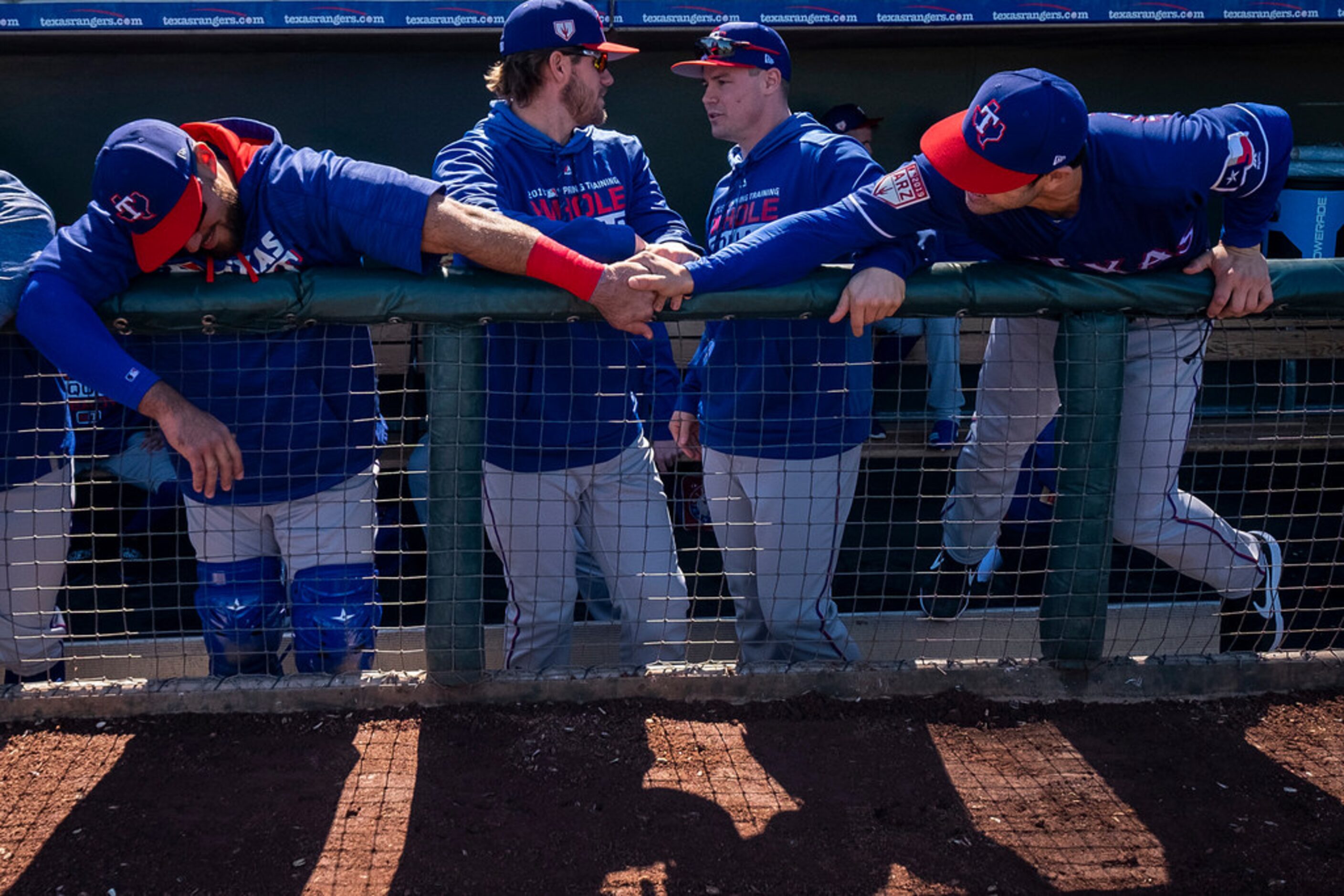 Texas Rangers infielder Chase d'Arnaud (right) reaches out to catcher Tony Sanchez accross...